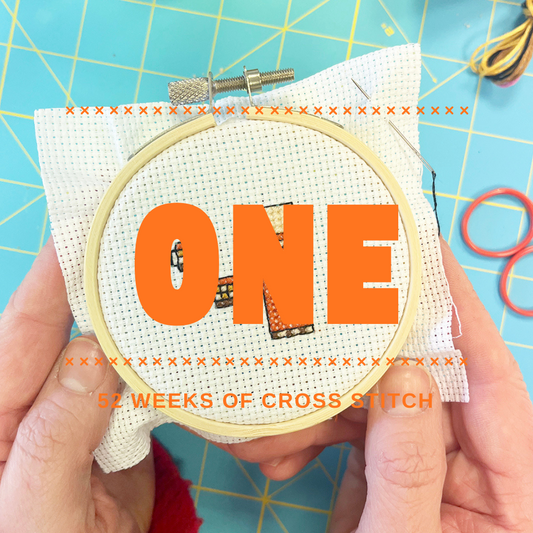 Image of cross stitch with the image 'ONE'