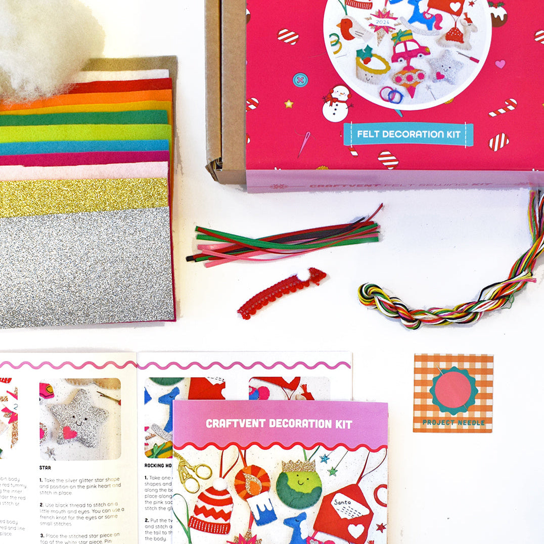 contents of the christmas decoration set featuring felts, glitter, threads, ribbons and instructions