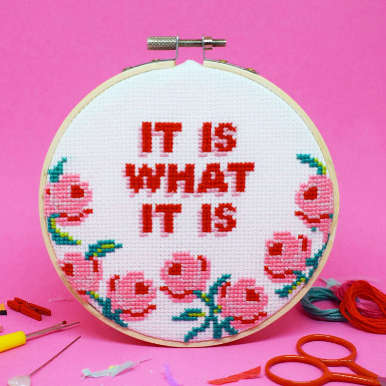 cross stitch design with it is what it is slogan and large pink roses