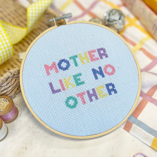a cross stitch hoop with 'mother like no other 'cross stitch design