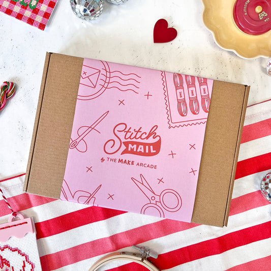 Stitch Mail box with pink and brown design on a white surface with decorative items.