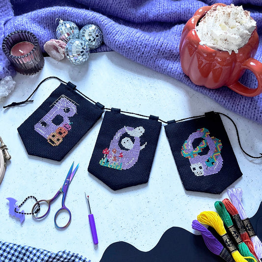 halloween cross stitch garland with the word 'BOO' spelt across it.