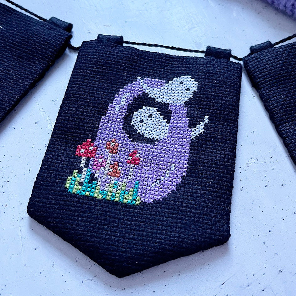 halloween cross stitch garland with the word 'BOO' spelt across it.