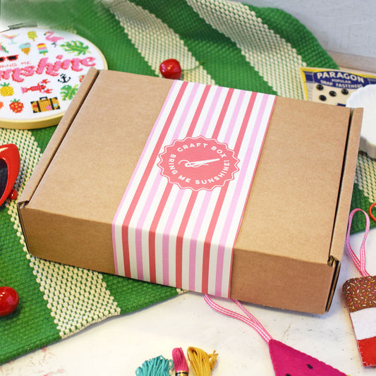cute craft box with stripy wrap. Box includes a felt lolly craft kit and 'bring me sunshine' cross stitch hoop.