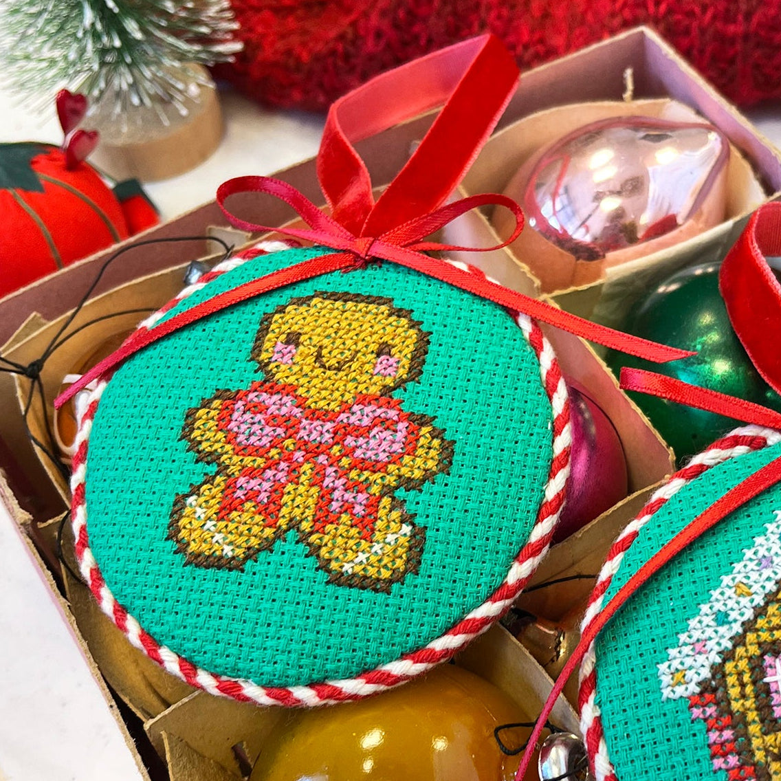 Decorative Christmas ornaments with a gingerbread design in a box.