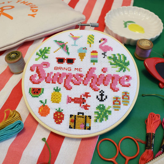 Bring Me Sunshine cross stitch kit with 6-inch hoop, colourful threads, Aida fabric, and instruction sheet on white background